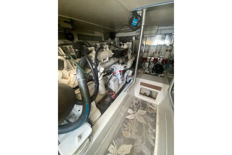 Slide: The Image of Engine room of a 2005 Ocean Yacht 50' Super Sport, showcasing mechanical components. - 28