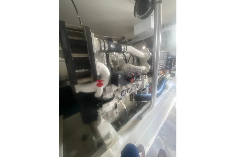Slide: The Image of Engine room of a 2005 Ocean Yacht 50' Super Sport, showcasing mechanical components. - 36
