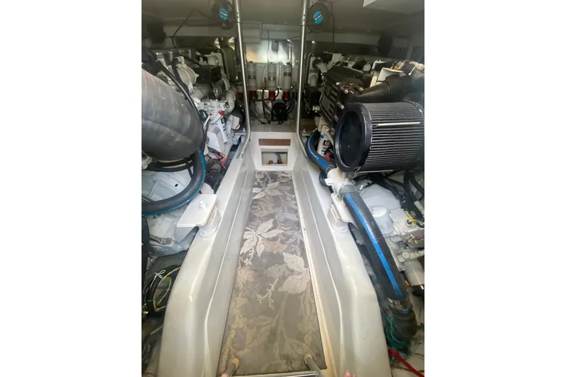 Slide: The Image of Engine room of a 2005 Ocean Yacht 50' Super Sport, showcasing dual engines and equipment. - 26