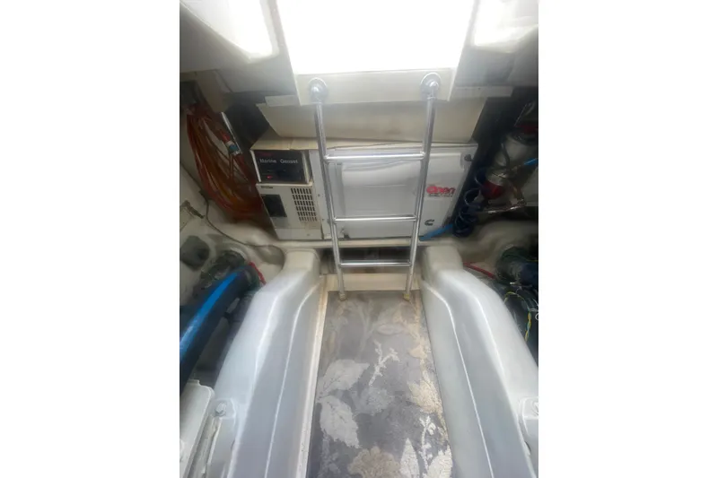 Slide: The Image of Engine room of a 2005 Ocean Yacht 50' Super Sport with ladder and equipment. - 39