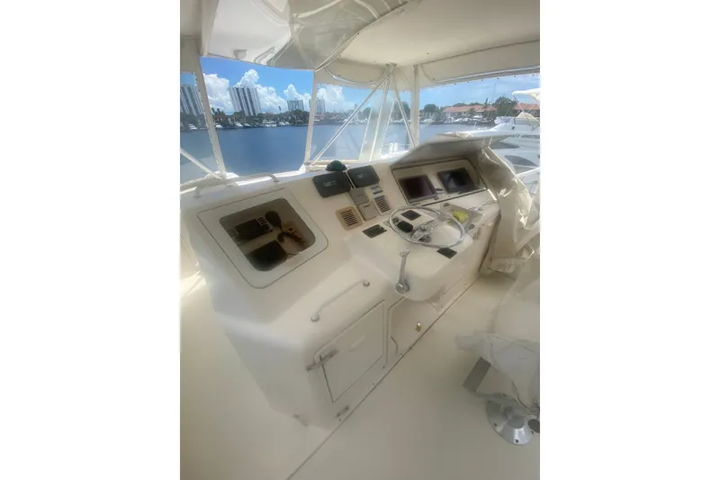 Slide: The Image of Helm of 2005 Ocean Yacht 50' Super Sport with navigational controls and waterfront view. - 25