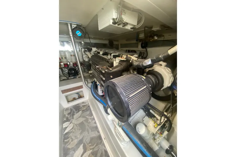 Slide: The Image of Engine room of a 2005 Ocean Yacht 50' Super Sport, showcasing detailed machinery. - 27