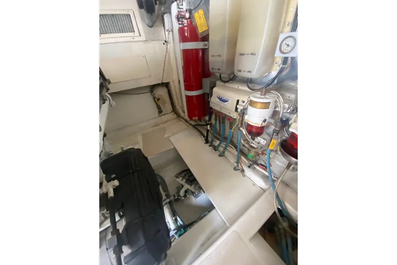 Slide: The Image of Engine room of a 2005 Ocean Yacht 50' Super Sport, featuring fire extinguisher and fuel systems. - 31