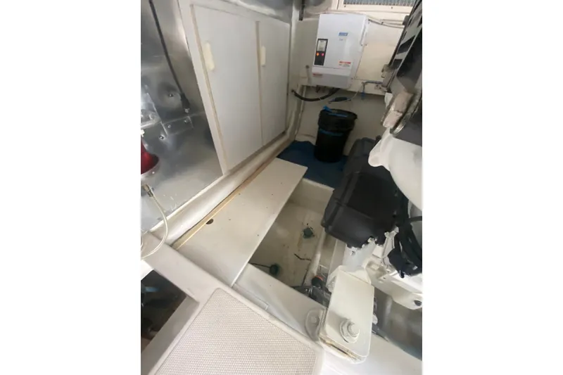 Slide: The Image of Engine room of a 2005 Ocean Yacht 50' Super Sport, featuring storage and equipment. - 30