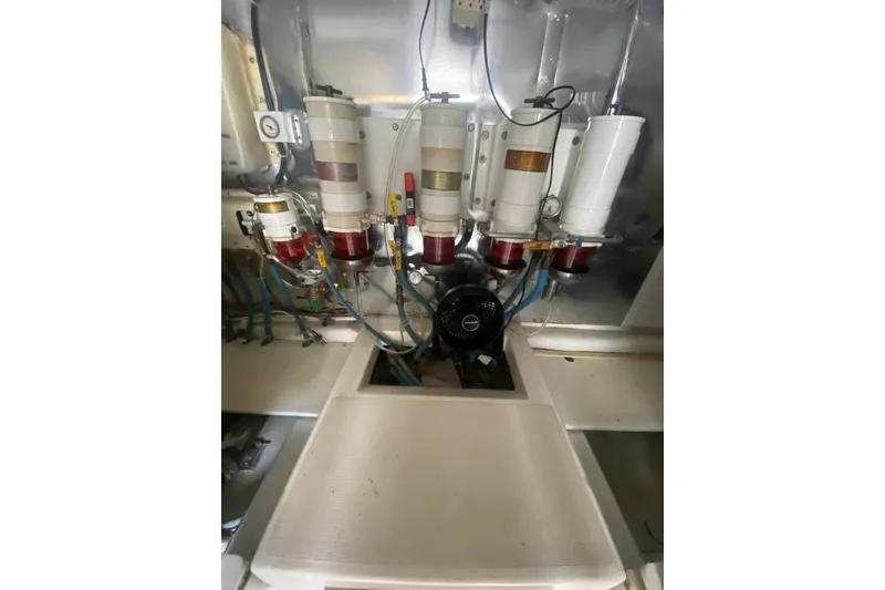 Slide: The Image of Engine room of a 2005 Ocean Yacht 50' Super Sport, showcasing fuel filters and piping. - 29