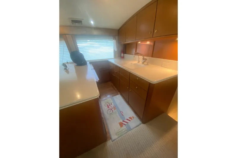 Slide: The Image of Luxurious kitchen interior of a 2005 Ocean Yacht 50' Super Sport, featuring wooden cabinetry. - 19