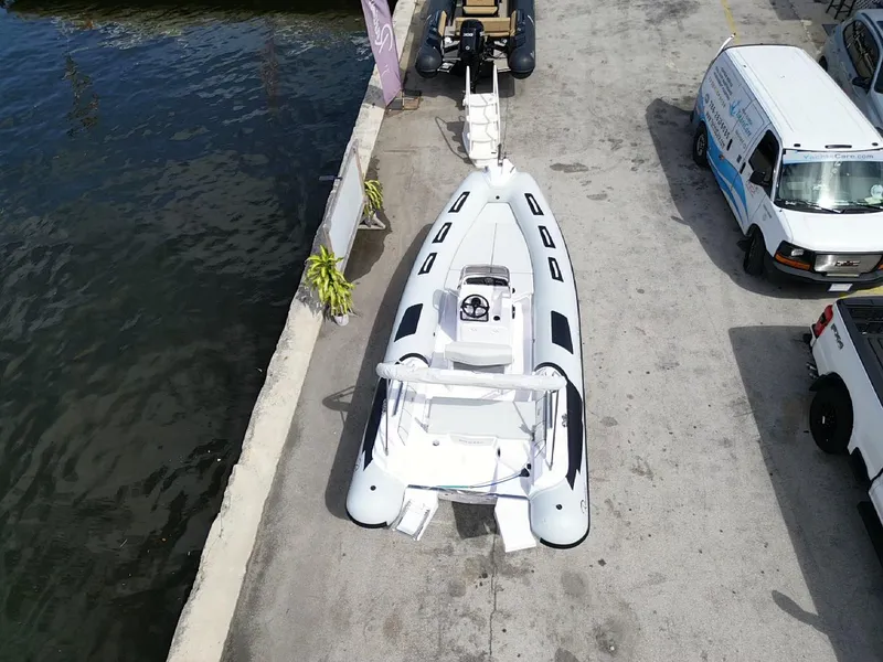 Slide: The Image of 2025 Ranieri CAYMAN 19 Sport boat docked at marina, aerial view. - 2