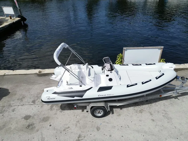 Slide: The Image of 2025 Ranieri CAYMAN 19 Sport boat on trailer by waterfront. - 1