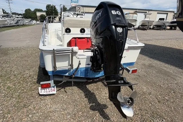 Slide: The Image of 2019 Boston Whaler 150 Montauk boat with Mercury 60 HP engine, parked on gravel. - 8