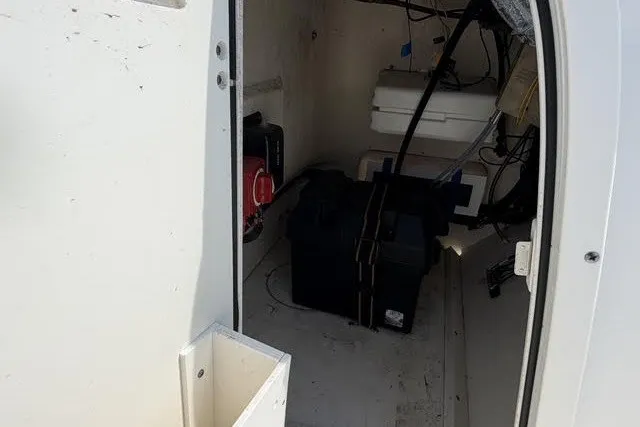 Slide: The Image of Interior view of a 2019 Boston Whaler 150 Montauk boat compartment with equipment. - 4