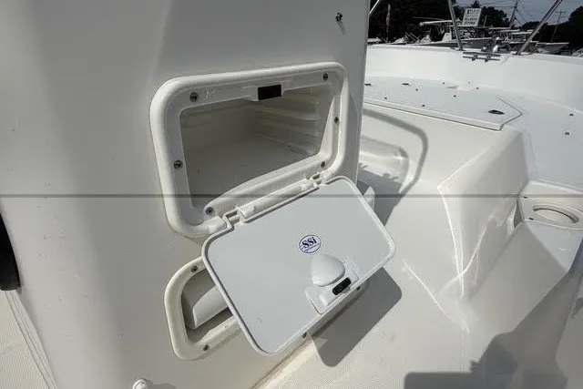 Slide: The Image of 2019 Boston Whaler 150 Montauk boat storage compartment with open hatch. - 14
