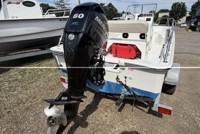 Slide: The Image of 2019 Boston Whaler 150 Montauk boat with Mercury 50 HP engine, parked on a trailer. - 9