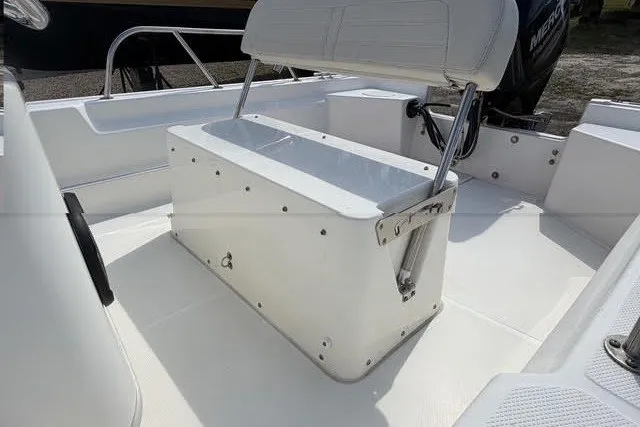 Slide: The Image of 2019 Boston Whaler 150 Montauk boat interior with seating and storage. - 5