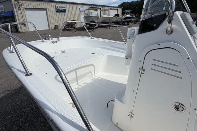 Slide: The Image of 2019 Boston Whaler 150 Montauk boat interior at a dealership. - 2