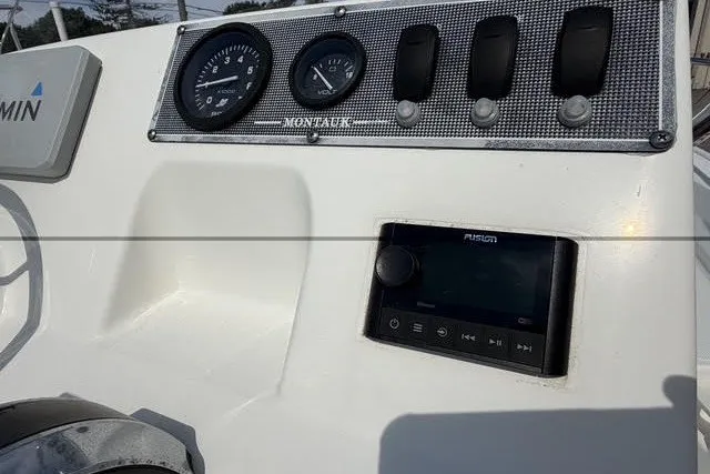 Slide: The Image of 2019 Boston Whaler 150 Montauk dashboard with gauges and controls. - 13
