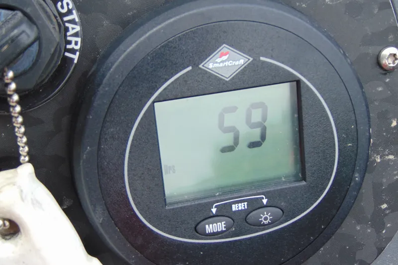 Slide: The Image of Digital display showing "59" on a Boomeranger 188, 2010 model dashboard. - 13