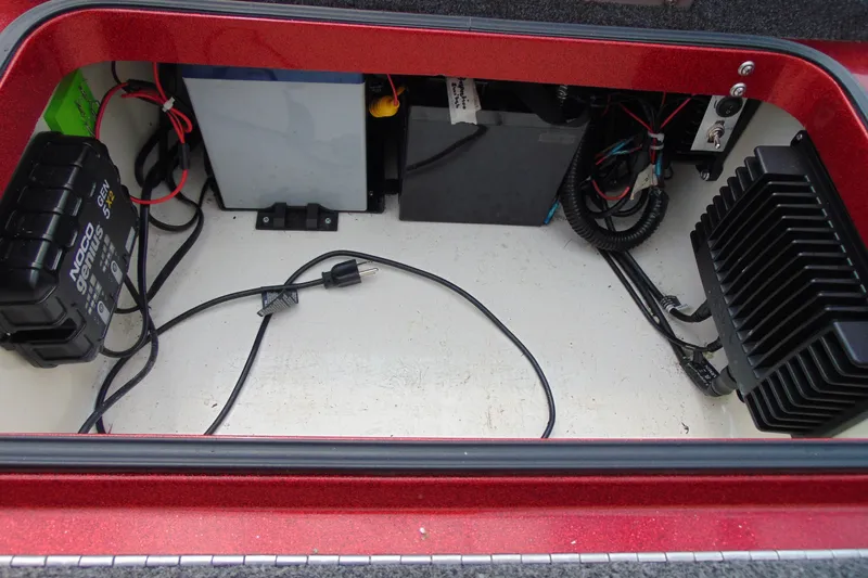 Slide: The Image of Storage compartment of a 2010 Boomeranger 188, featuring electrical components and wiring. - 18