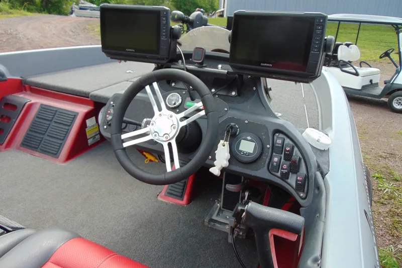 Slide: The Image of Cockpit of a 2010 Boomeranger 188 boat with steering wheel and navigation screens. - 6