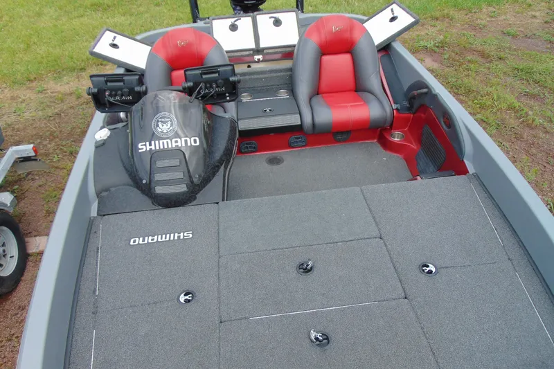 Slide: The Image of Boomeranger 188 boat interior, featuring red and gray seats, Shimano branding, and storage compartments. - 20