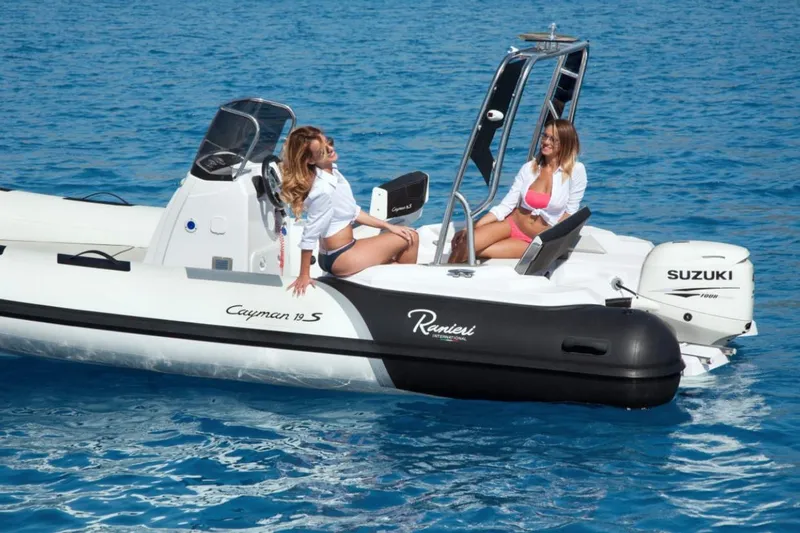 Slide: The Image of 2025 Ranieri CAYMAN 19 Sport boat on blue water with two people relaxing. - 5