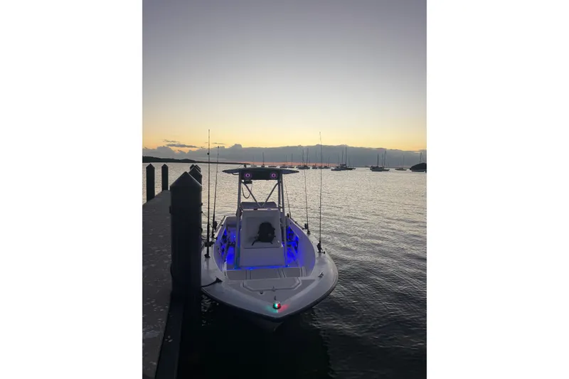 Slide: The Image of 1992 Hydra-Sports 2000 CC boat docked at sunset with blue interior lights. - 6
