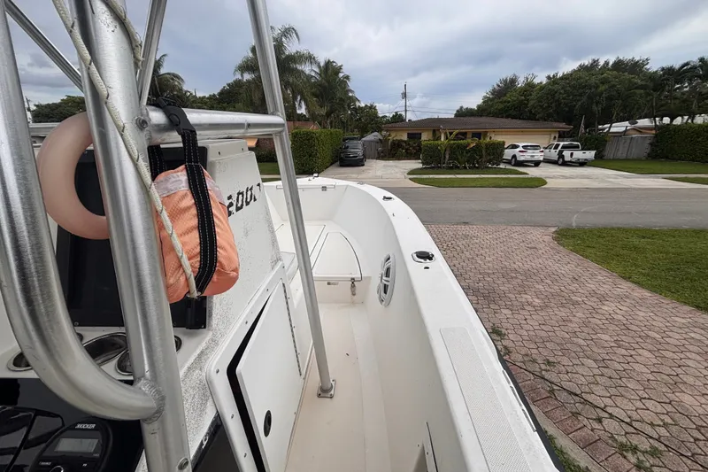 Slide: The Image of 1992 Hydra-Sports 2000 CC boat parked in a residential driveway, overcast sky. - 24