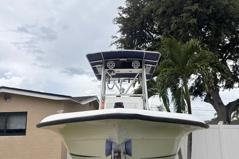 Slide: The Image of 1992 Hydra-Sports 2000 CC boat with T-top, parked near a house and palm trees. - 13