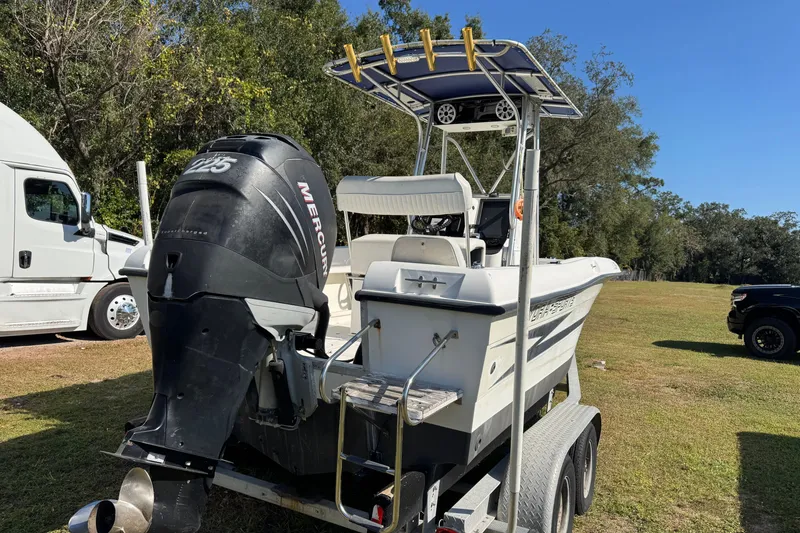 Slide: The Image of 1992 Hydra-Sports 2000 CC boat with Mercury outboard motor on trailer, parked outdoors. - 1
