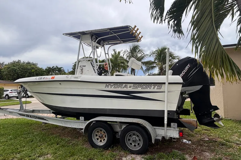 Slide: The Image of 1992 Hydra-Sports 2000 CC boat on trailer, parked near palm trees. - 9