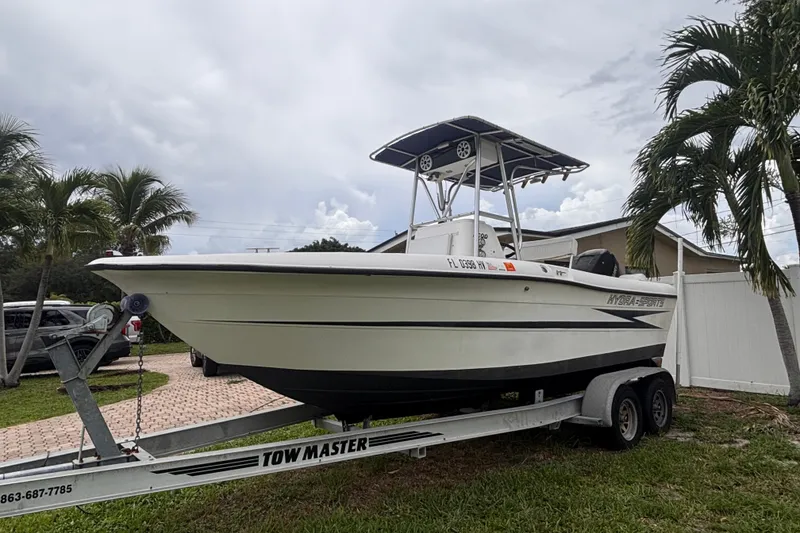 Slide: The Image of 1992 Hydra-Sports 2000 CC boat on trailer, parked near palm trees. - 11