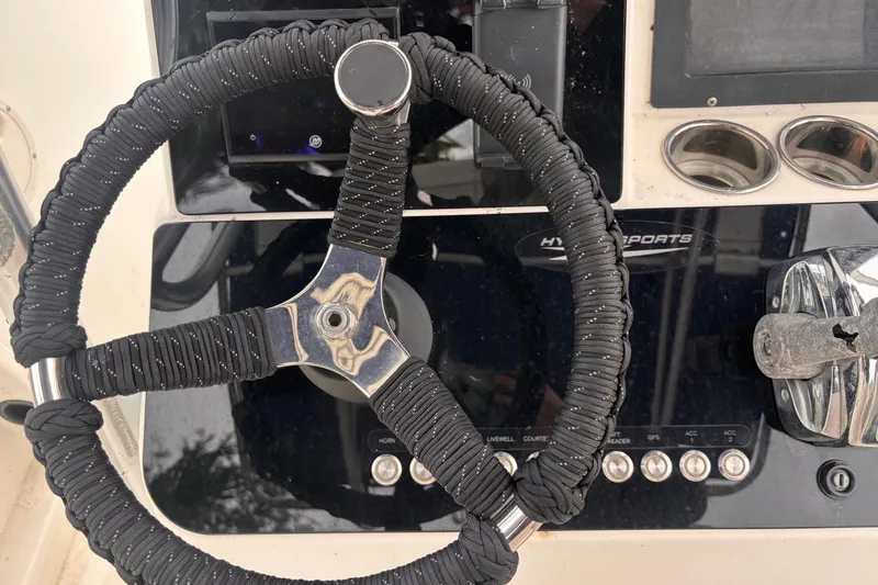 Slide: The Image of Steering wheel of a 1992 Hydra-Sports 2000 CC boat with black rope wrap. - 28