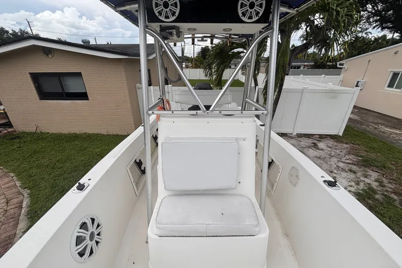 Slide: The Image of 1992 Hydra-Sports 2000 CC boat interior with seating and speakers, parked in a residential yard. - 33