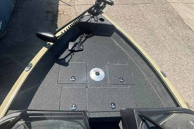 Slide: The Image of 2027 Tracker Pro Guide V-16 WT boat deck with storage compartments and trolling motor. - 6