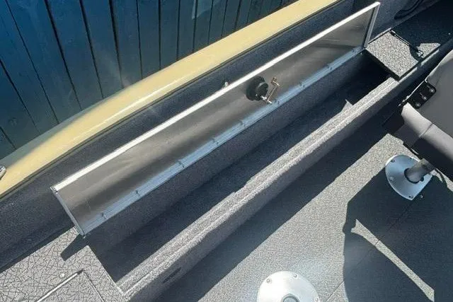 Slide: The Image of 2027 Tracker Pro Guide V-16 WT boat interior with open storage compartment. - 16