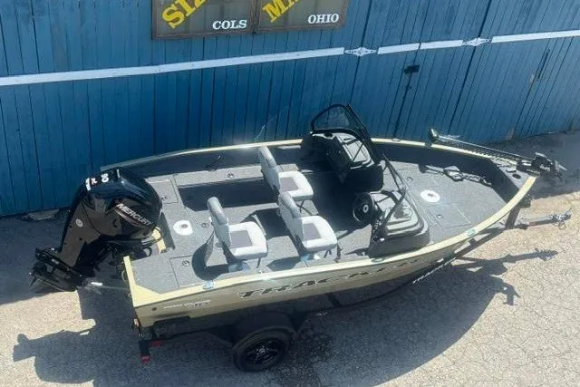 Slide: The Image of 2027 Tracker Pro Guide V-16 WT fishing boat with Mercury engine, parked outdoors. - 5