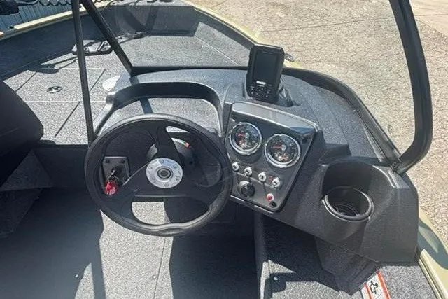 Slide: The Image of 2027 Tracker Pro Guide V-16 WT boat dashboard with steering wheel and gauges. - 10