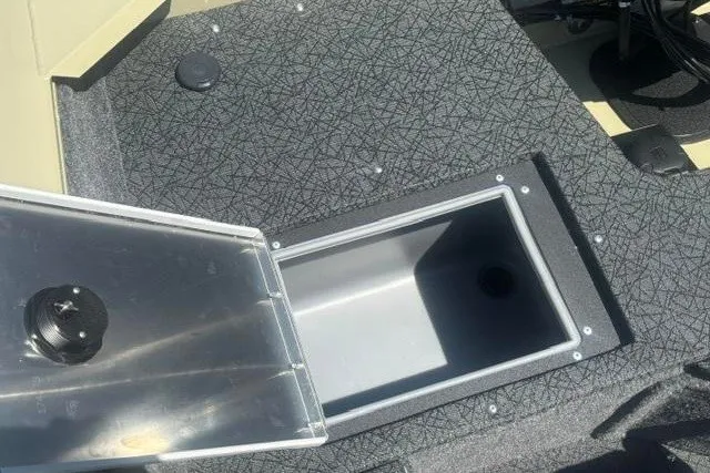 Slide: The Image of 2027 Tracker Pro Guide V-16 WT boat storage compartment with open lid, showcasing interior space. - 14