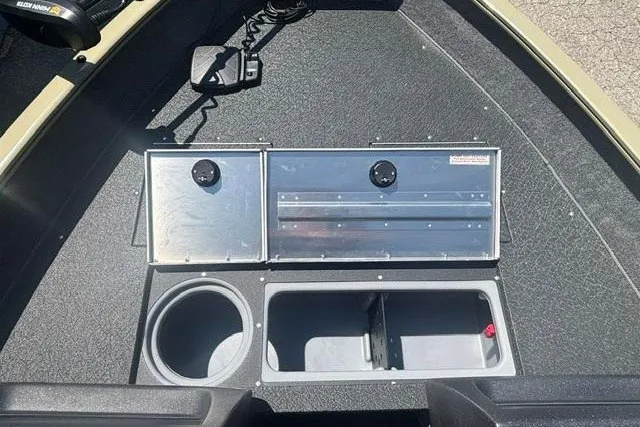 Slide: The Image of 2027 Tracker Pro Guide V-16 WT boat interior with storage compartments and cup holder. - 7