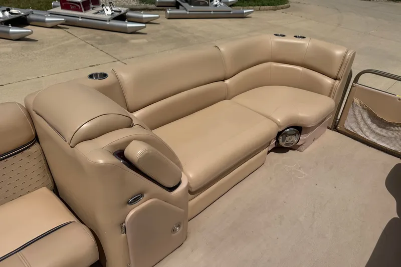 Slide: The Image of Beige seating on 2008 Godfrey San Pan 2500 pontoon boat, featuring cup holders and storage. - 6