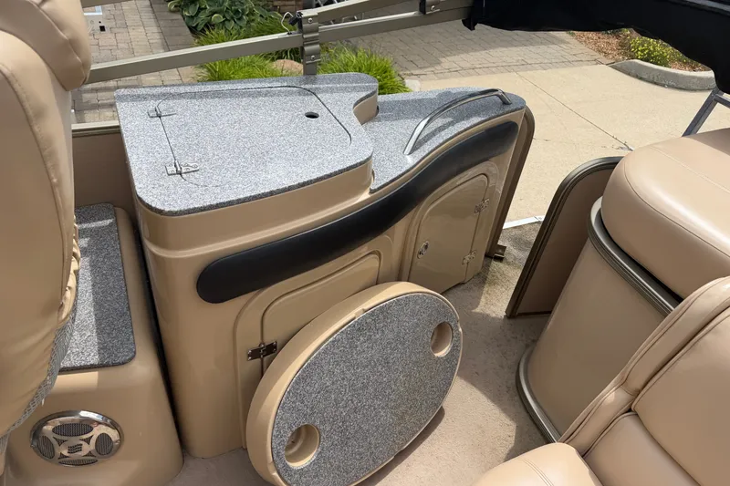 Slide: The Image of Interior of a 2008 Godfrey San Pan 2500 pontoon boat with beige seating and storage compartments. - 14
