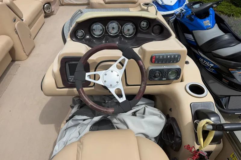 Slide: The Image of Steering console of a 2008 Godfrey San Pan 2500 pontoon boat with gauges and controls. - 13