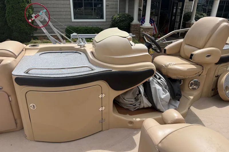Slide: The Image of 2008 Godfrey San Pan 2500 boat interior with beige seating and control panel. - 11