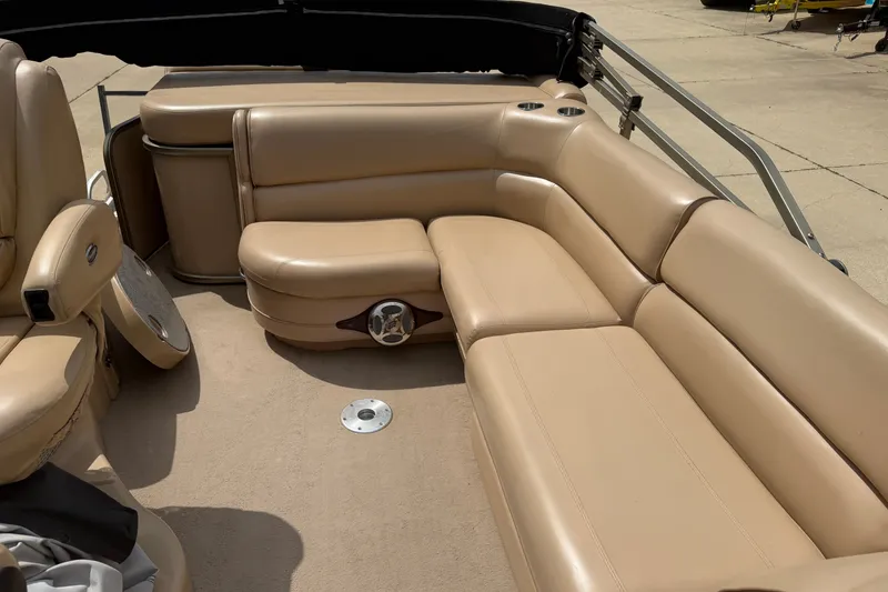 Slide: The Image of 2008 Godfrey San Pan 2500 boat interior with beige leather seating and cup holders. - 10