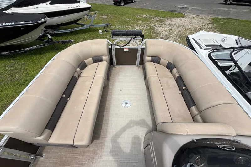 Slide: The Image of 2020 Sun Tracker Party Barge 22 DLX with spacious seating, parked on grass. - 9