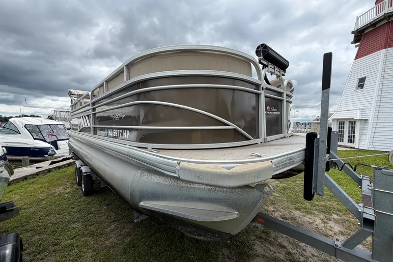 Slide: The Image of 2020 Sun Tracker Party Barge 22 DLX pontoon boat on trailer, cloudy sky background. - 13