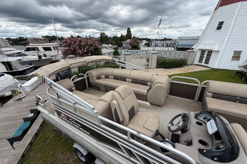 Slide: The Image of 2020 Sun Tracker Party Barge 22 DLX pontoon boat docked at marina under cloudy skies. - 15