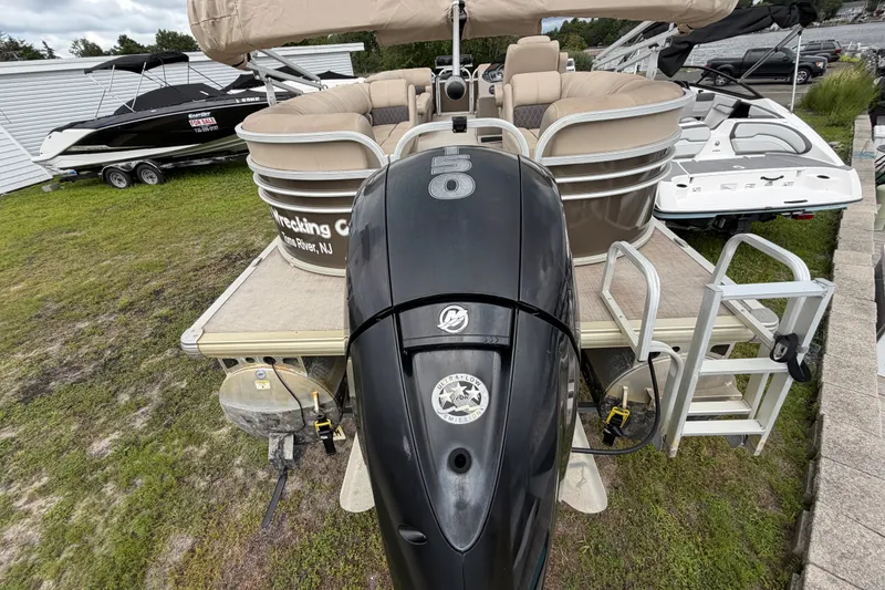Slide: The Image of 2020 Sun Tracker Party Barge 22 DLX with outboard motor, docked on grass. - 12