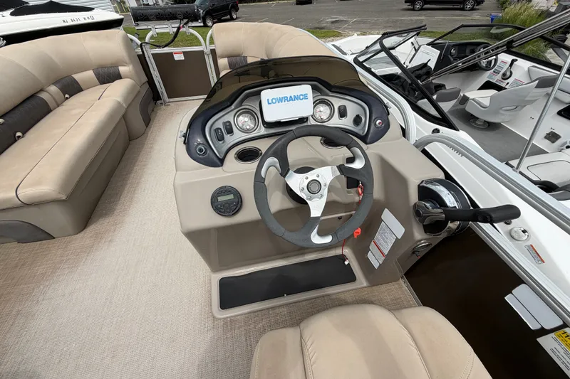 Slide: The Image of Interior of 2020 Sun Tracker Party Barge 22 DLX with steering console and seating. - 11