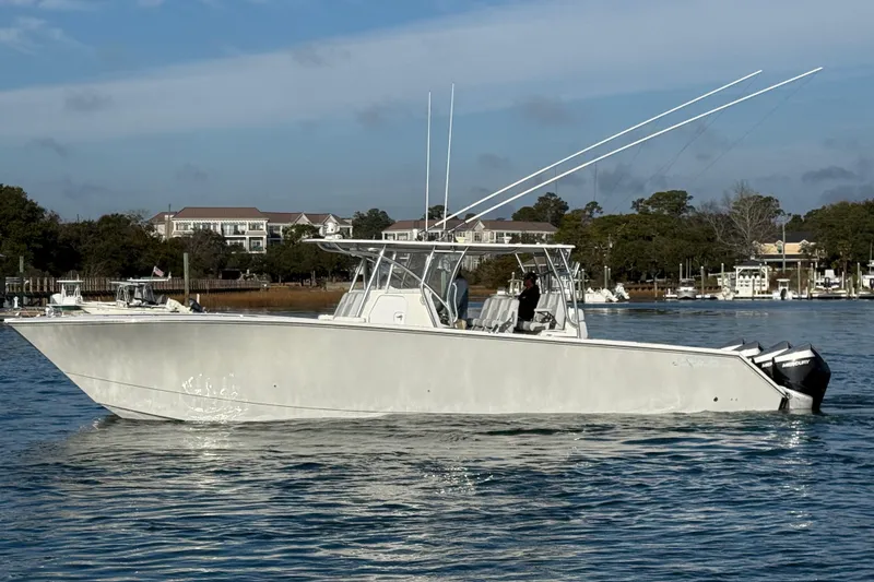 Slide: The Image of 2021 SeaHunter 41 CTS boat on calm water with scenic background. - 4
