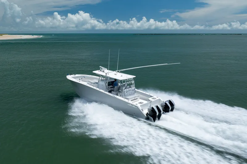 Slide: The Image of 2021 SeaHunter 41 CTS boat cruising on open water under a clear blue sky. - 14